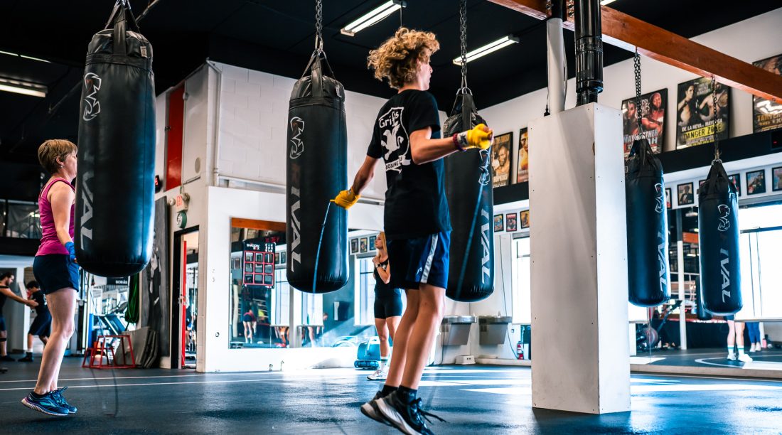 At Griffins Boxing [North Vancouver] a teenage boxer warms up in the boxing gym, jumping rope to prepare for his training session.